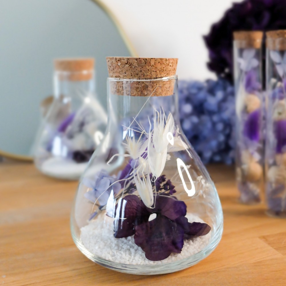 Fiole Erlenmeyer en verre contenant des fleurs séchées crème, parme, violet. Format moyen. Collection Milka