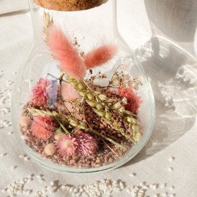 Fiole Erlenmeyer en verre contenant des fleurs séchées roses et vertes. Format moyen.
