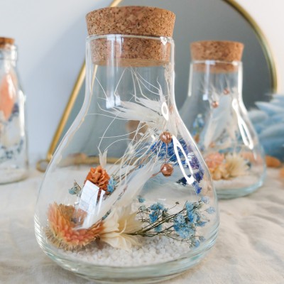 Fiole Erlenmeyer en verre contenant des fleurs séchées blanches, pêche et bleu ciel. Format moyen. Collection Pêche Bleue